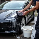 Washing a Tesla with the two-bucket method