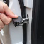 Unlocking a car door with a block tool involves carefully inserting the wedge and creating a gap.