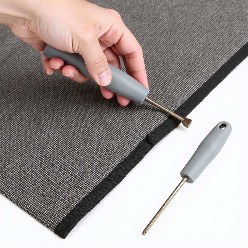 Using an upholstery trim removal tool to remove staples