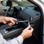 A person carefully using a slim jim tool to open a locked car door