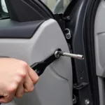 Using Car Trim Removal Tool on Door Panel