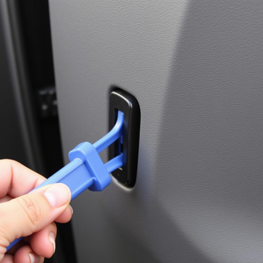 Using a Panel Removal Tool on a Car Door