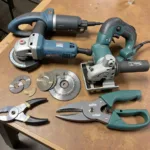 A selection of tools used for cutting car fenders, including an air nibbler, angle grinder, jigsaw, and electric shears.