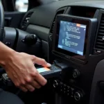 Technician using an auto car diagnostic scanner tool connected to the OBD-II port of a vehicle