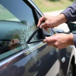 Car escape tool being used to break a car window in an emergency situation