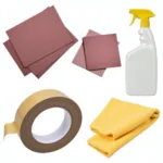 Car paint preparation tools: sandpaper, masking tape, cleaning solution.