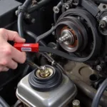 Car stretch belt tool being used to install a serpentine belt