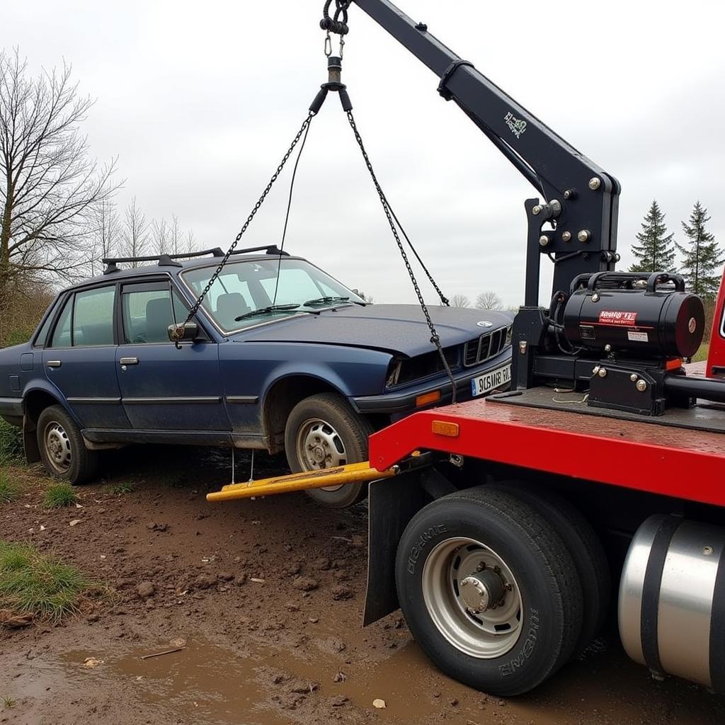 Hydraulic winch recovering a heavily damaged salvage car