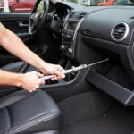 Mechanic Using Car Closing Tool: A mechanic expertly utilizes a specialized car closing tool during a diagnostic procedure