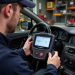 Mechanic using a diagnostic tool to reprogram car keys in a workshop