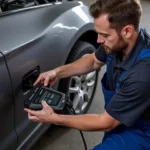 Mechanic Using an OBD2 Scanner on a Vehicle