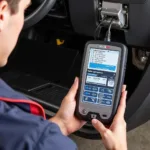 Mechanic using a Solus Snap-on scanner to diagnose a car engine problem