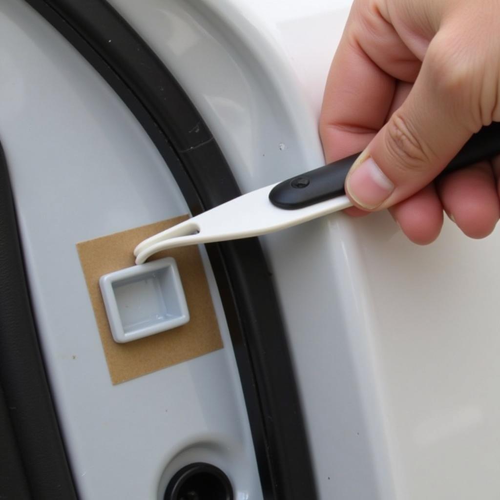 Using Car Trim Removal Tool on Door Panel