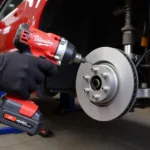 Using a cordless impact wrench to remove brake rotor bolts