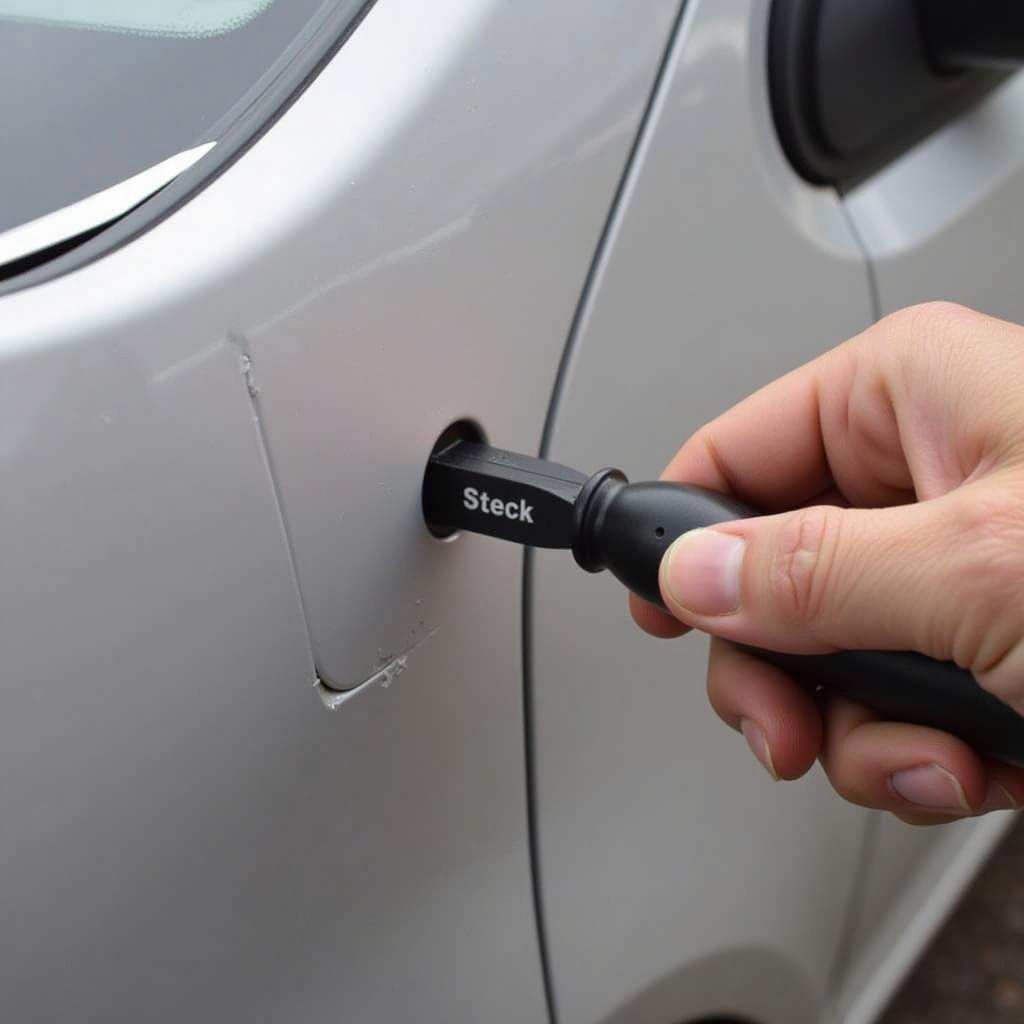 Using Steck Dent Repair Tool on Car Door