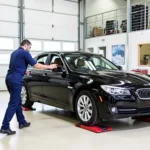 Mechanic Using Vehicle Dollies to Move a Car